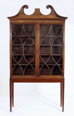 Lot 567 - A George III mahogany bookcase with swan neck...