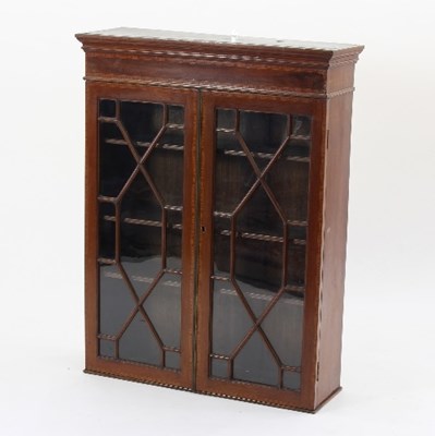 Lot 585 - An Edwardian mahogany bookcase banded in...