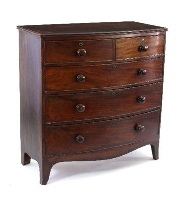 Lot 587 - A George IV mahogany chest of three long and...