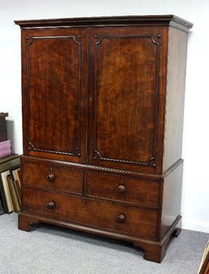 Lot 589 - A George III mahogany linen press with dentil...