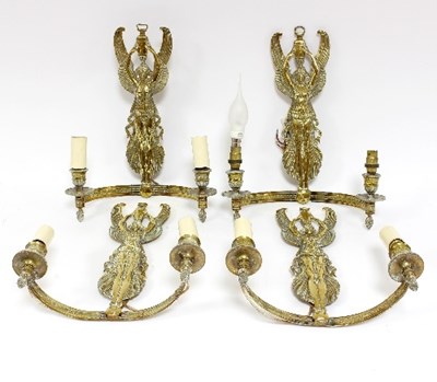 Lot 601 - Four Empire style wall lights with winged...