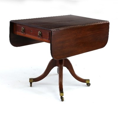 Lot 615 - A Regency mahogany two-flap table on a turned...