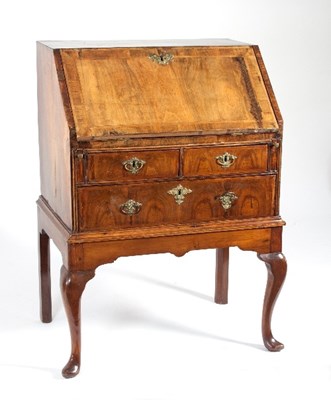 Lot 617 - A George I walnut bureau with two short and...