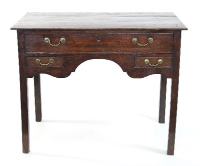 Lot 645 - An 18th Century oak lowboy, the triple-plank...