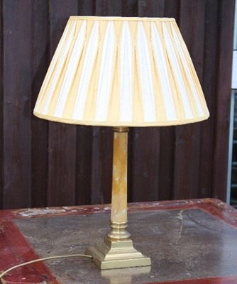 Lot 658 - A table lamp of column form on square brass base