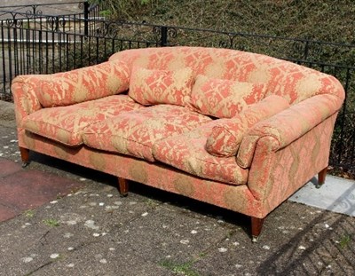 Lot 659 - A large upholstered sofa on three tapering...