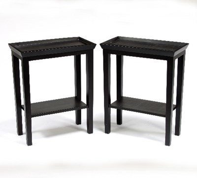 Lot 695 - A pair of modern two-tier ebonised side tables,...