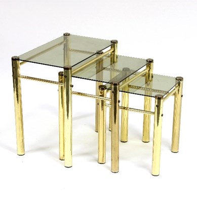 Lot 698 - A nest of three brass framed tables, with...