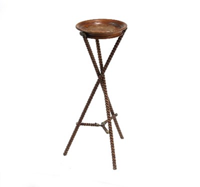 Lot 700 - A turned walnut bowl on a folding tripod stand,...