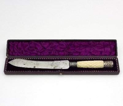 Lot 9 - A cased bread knife with carved ivory handle