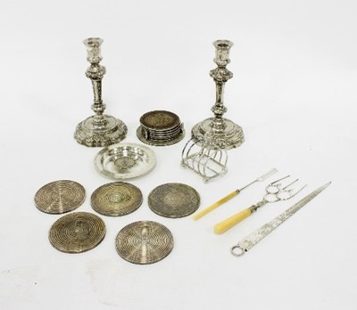 Lot 26 - A pair of white metal candlesticks, the...