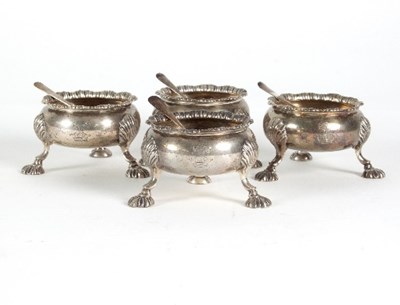 Lot 110 - A set of four George II silver cauldron salts,...