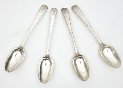 Lot 135 - A set of four George III silver tablespoons,...