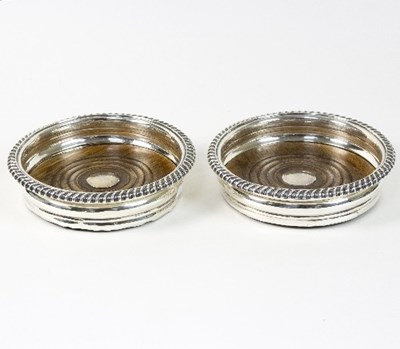 Lot 147 - A pair of William IV silver wine coasters,...