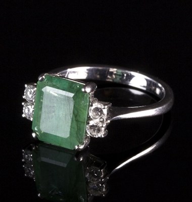 Lot 224 - An emerald and diamond dress ring, the emerald...