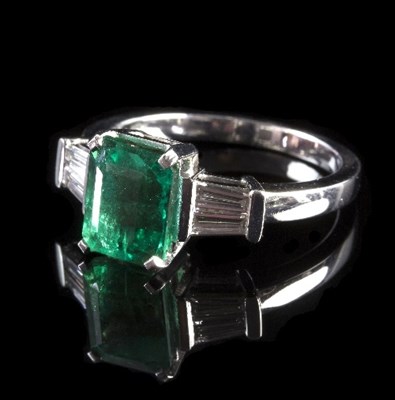 Lot 237 - An emerald and diamond dress ring, the emerald...