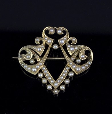 Lot 239 - A Victorian half pearl set brooch of shield...