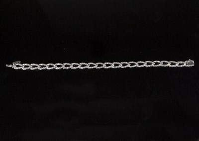 Lot 268 - A diamond set bracelet of leaf shaped links...