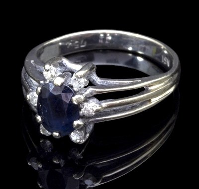 Lot 282 - A sapphire and diamond ring, the central oval...