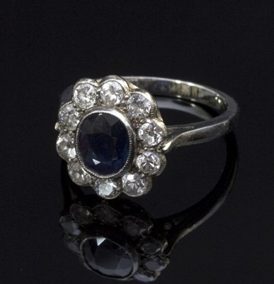 Lot 287 - A sapphire and diamond cluster ring, the...