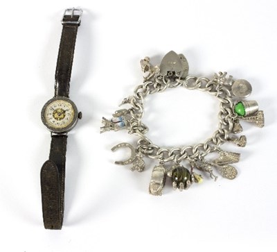 Lot 310 - A silver charm bracelet with seventeen charms...