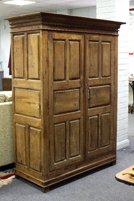 Lot 365 - A 20th Century teak cupboard enclosed by...