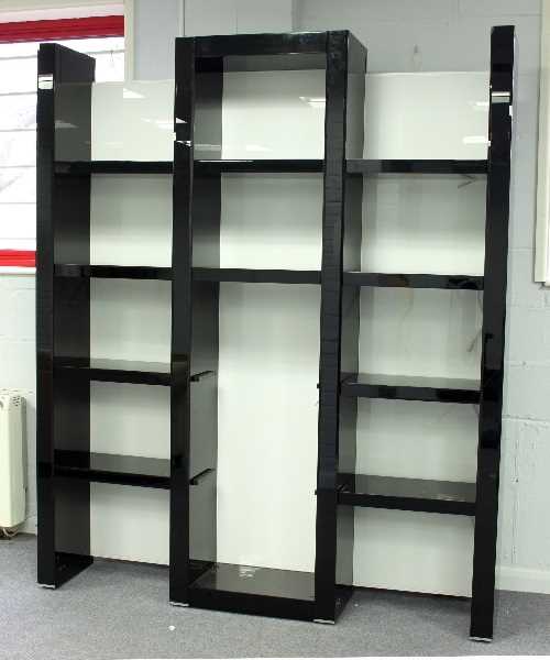 Lot 370 - A tall gloss black shelving unit, 218cm high