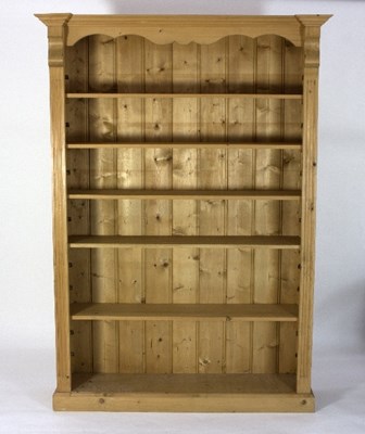 Lot 427 - A modern pine bookcase with shaped frieze,...