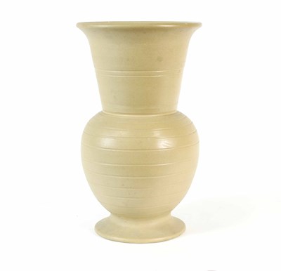 Lot 558 - A tall stylised stoneware vase in the style of...