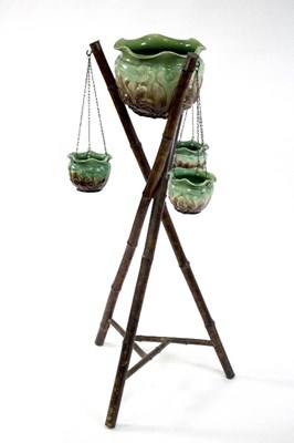 Lot 567 - An Art Nouveau jardini?re stand with green and...