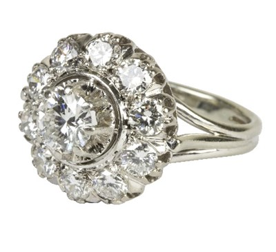 Lot 544 - A diamond cluster ring, the central brilliant...