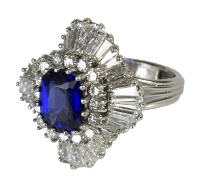 Lot 547 - A sapphire and diamond cluster ring, the...