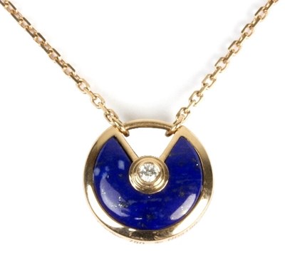 Lot 550 - A Cartier lapis lazuli and diamond set pendant...