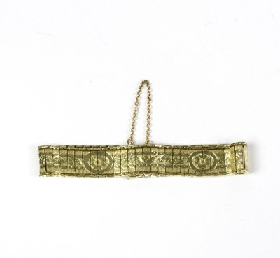 Lot 560 - A 14ct gold fancy link bracelet with engraved...