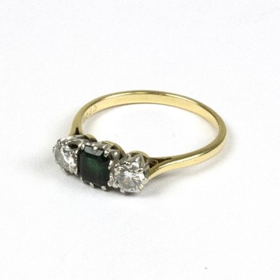 Lot 567 - An emerald and diamond dress ring to an 18ct...