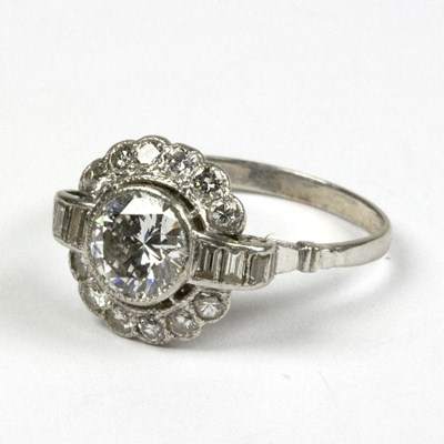 Lot 575 - A diamond cluster ring, the central circular...