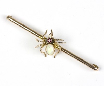 Lot 595 - A gold bar brooch, centred by a ruby and opal...