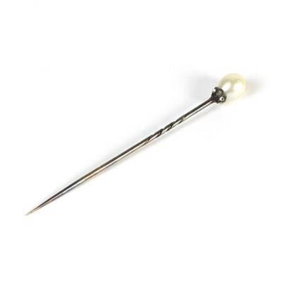 Lot 600 - A natural pearl and diamond pin, the ovoid...