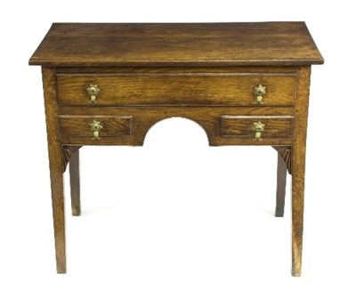 Lot 768 - An oak kneehole desk fitted three drawers on...