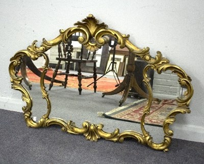 Lot 772 - A gilt wall mirror, the frame decorated...