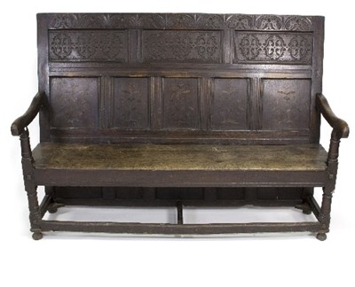 Lot 776 - An 18th Century oak settle carved with floral...