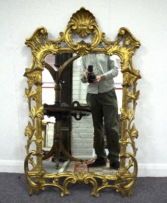 Lot 786 - A giltwood carved wall mirror, with pierced...