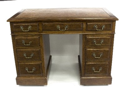 Lot 788 - A 20th Century oak pedestal desk with tooled...