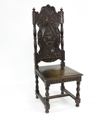 Lot 801 - A carved oak hall chair, with lion mask carved...