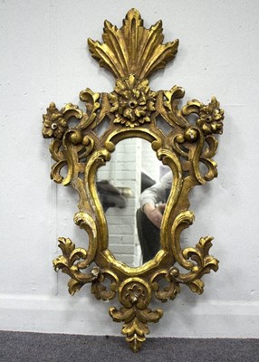 Lot 807 - A gilt gesso wall mirror, the cartouche mirror...