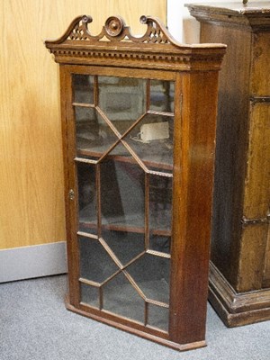 Lot 819 - A mahogany corner cupboard with astragal...