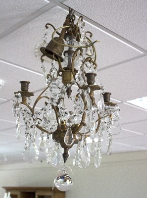 Lot 832 - A four-branch chandelier of fluted scrolling...