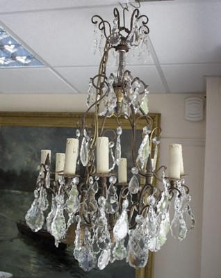 Lot 833 - A twelve-branch eight-light chandelier hung...