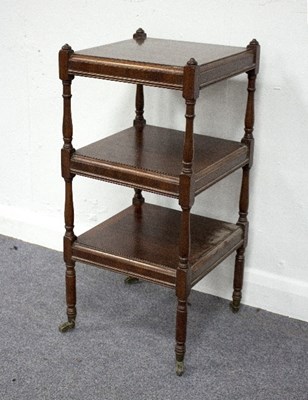 Lot 846 - A mahogany three-tier whatnot, fitted three...