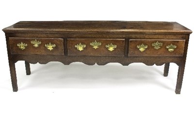 Lot 851 - An oak dresser base fitted three drawers above...